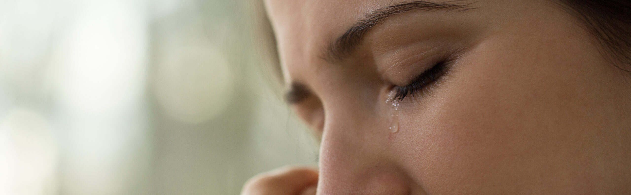 Close-up of young woman with problems crying